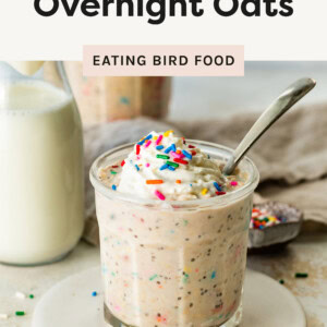 Photo of the Birthday Cake Overnight Oats in a jar with a spoon and sprinkles on top.