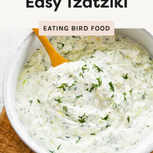 A photo of the Tzatziki in a bowl with a wooden spoon