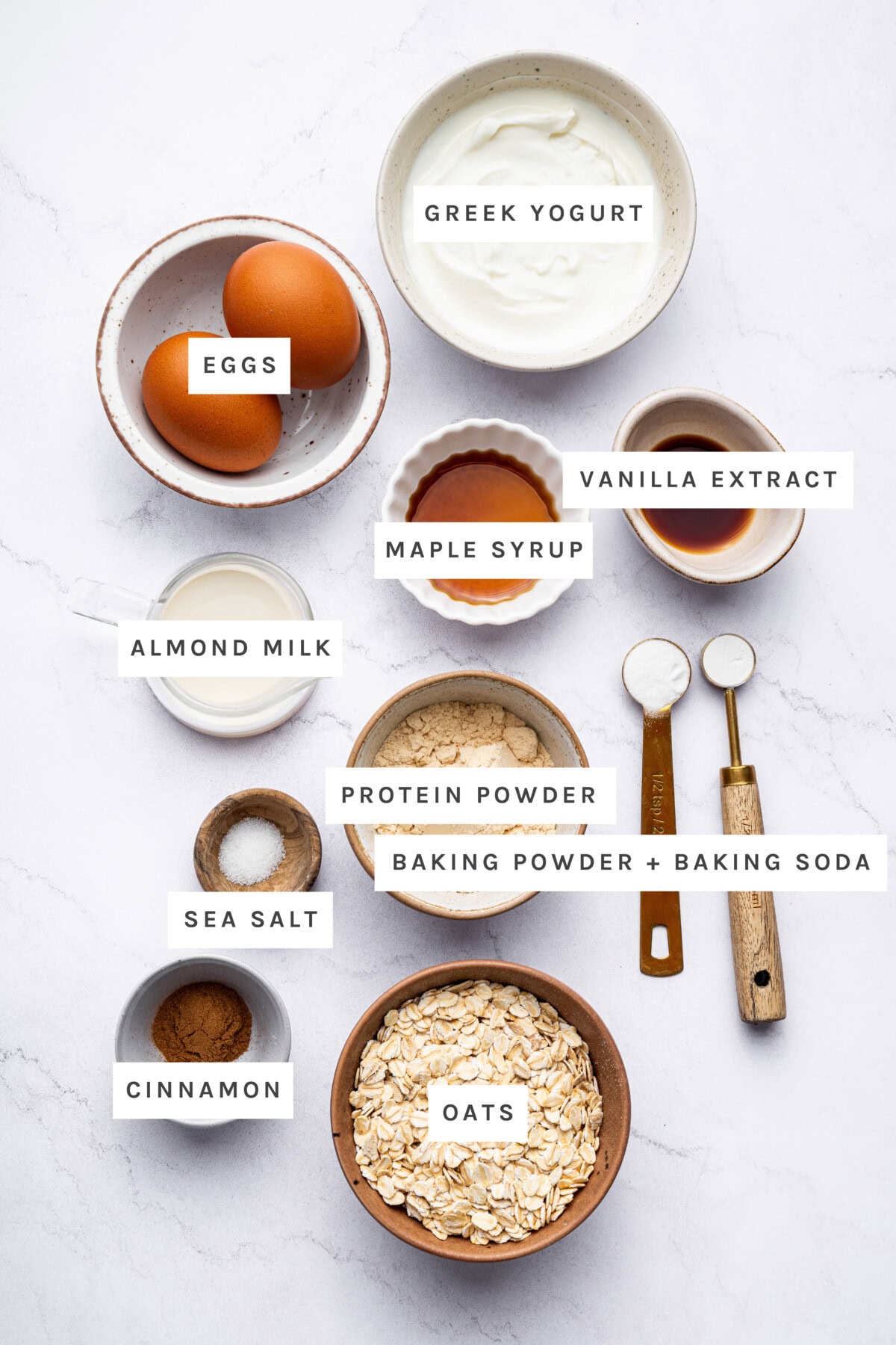 Ingredients to make Protein Waffles: Eggs, Greek Yogurt, Cinnamon, Sea Salt, Baking Soda, Baking Powder, Oats, Vanilla Extract, Maple Syrup, Almond Milk and Eggs