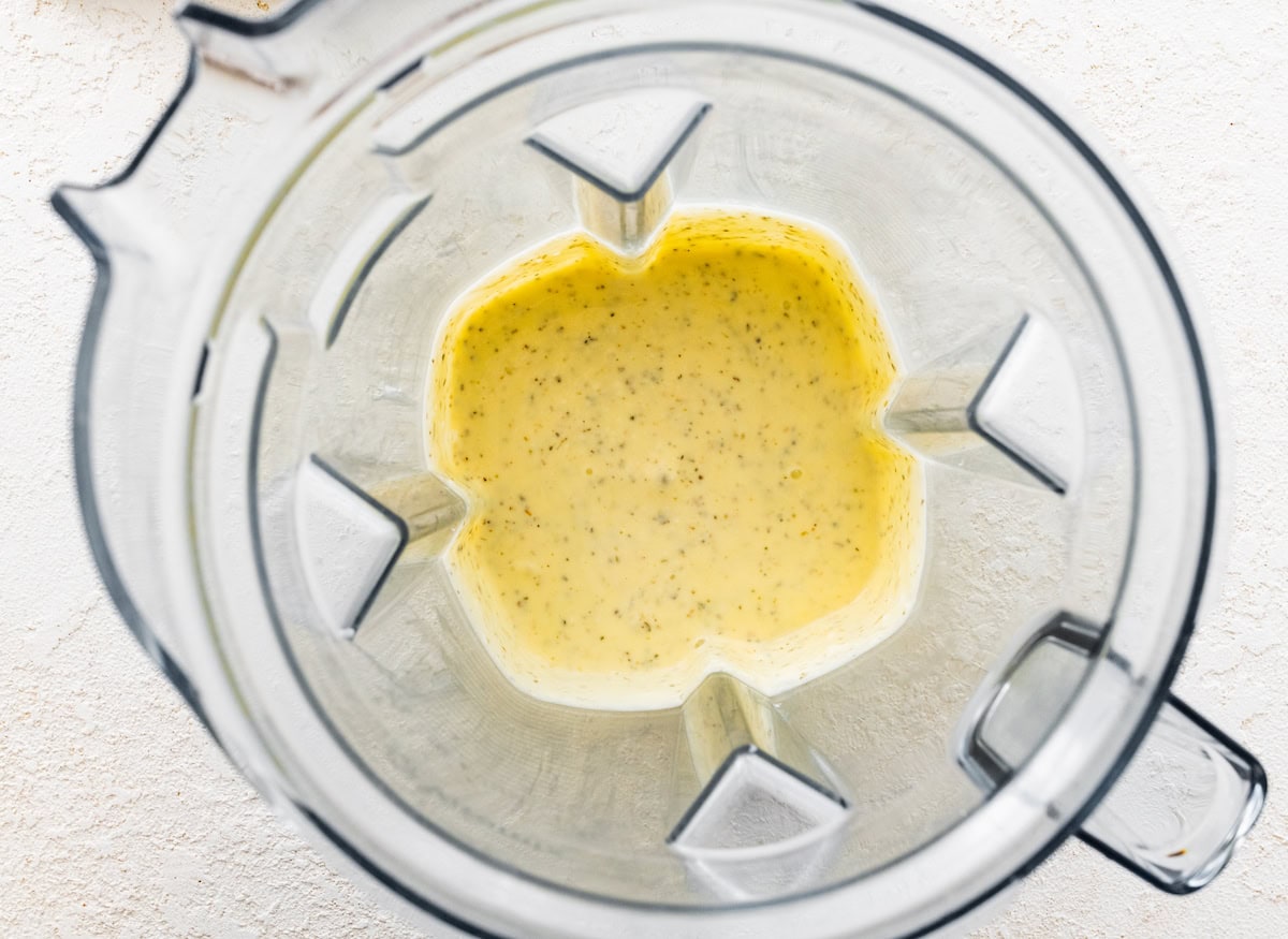 The cottage cheese flatbread ingredients (cottage cheese, eggs, garlic powder, onion powder and oregano) blended together in the base of a blender.