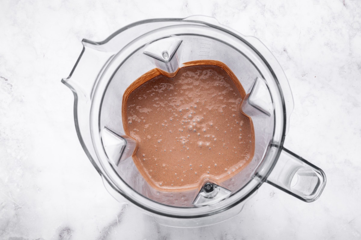 The blended cottage cheese chocolate mousse in the base of a blender.
