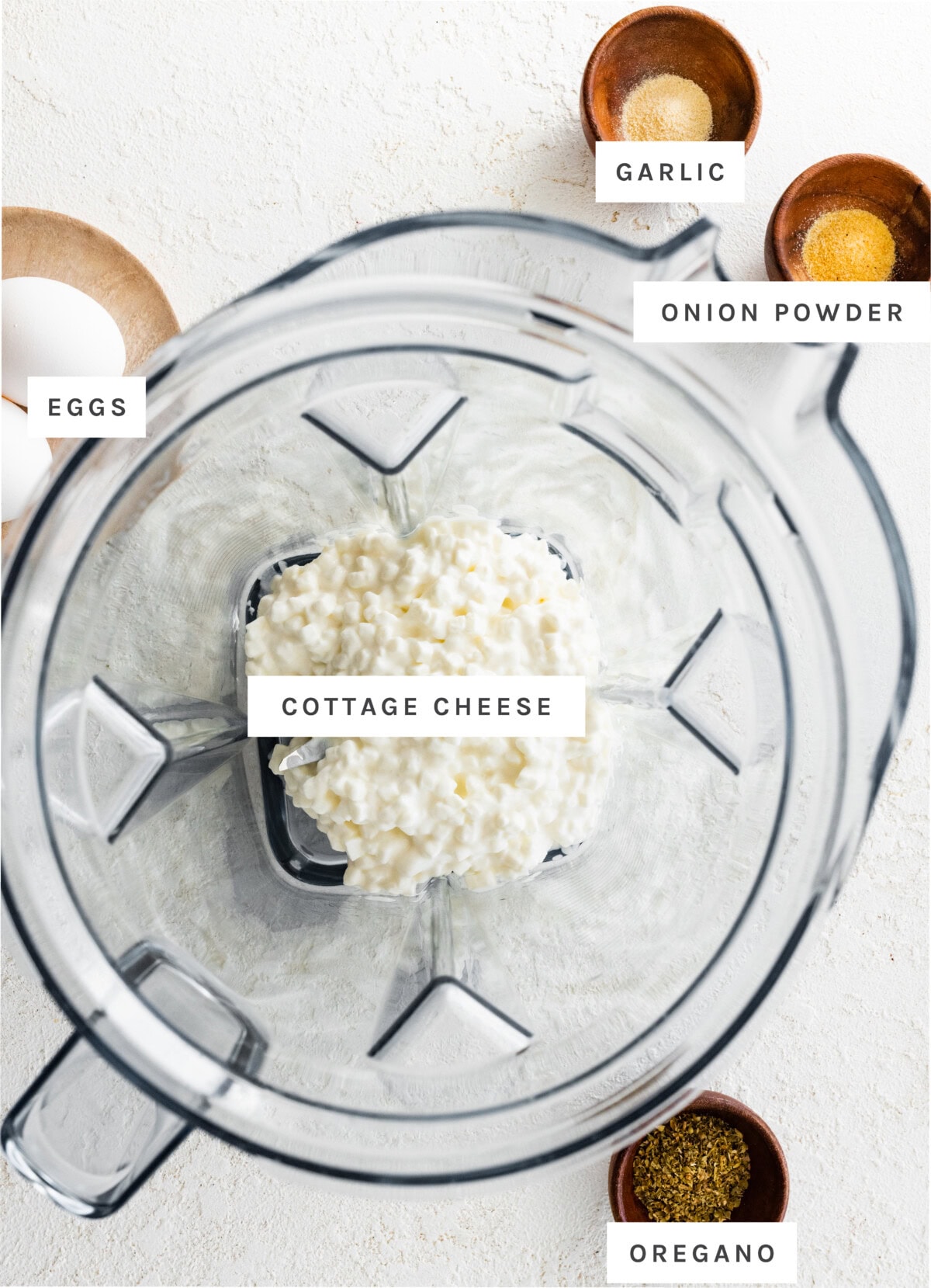 Ingredients for cottage cheese flatbread: cottage cheese, onion powder, garlic powder, eggs, and oregano.