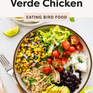 A central image of a burrito bowl with shredded salsa verde chicken, corn salsa, lettuce, cherry tomatoes, black beans, white rice, avocado slices, and lime wedges.