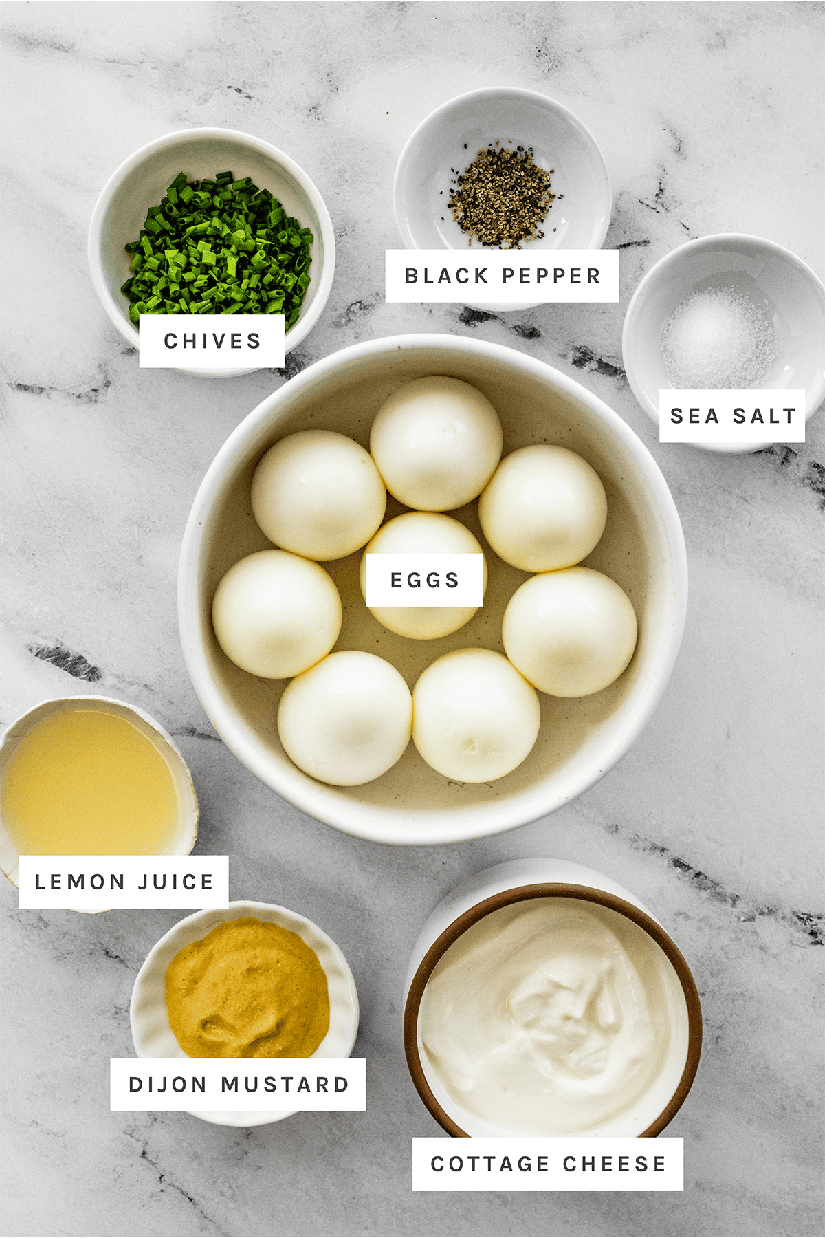Ingredients measured out to make Cottage Cheese Egg Salad: Chives, Black Pepper, Sea Salt, Eggs, Lemon Juice, Dijon Mustard, Cottage Cheese