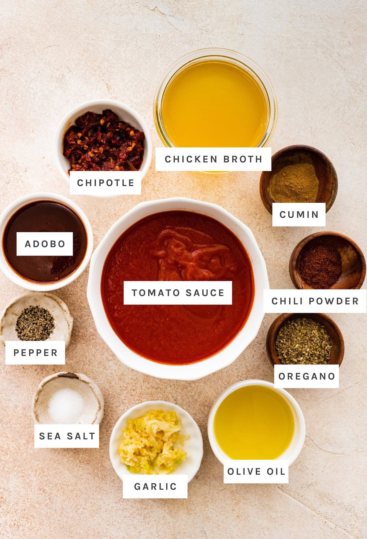 Enchilada Sauce ingredients: Tomato sauce, chicken broth, chipotle, adobo, cumin, chili powder, oregano, olive oil, garlic, sea salt, pepper.