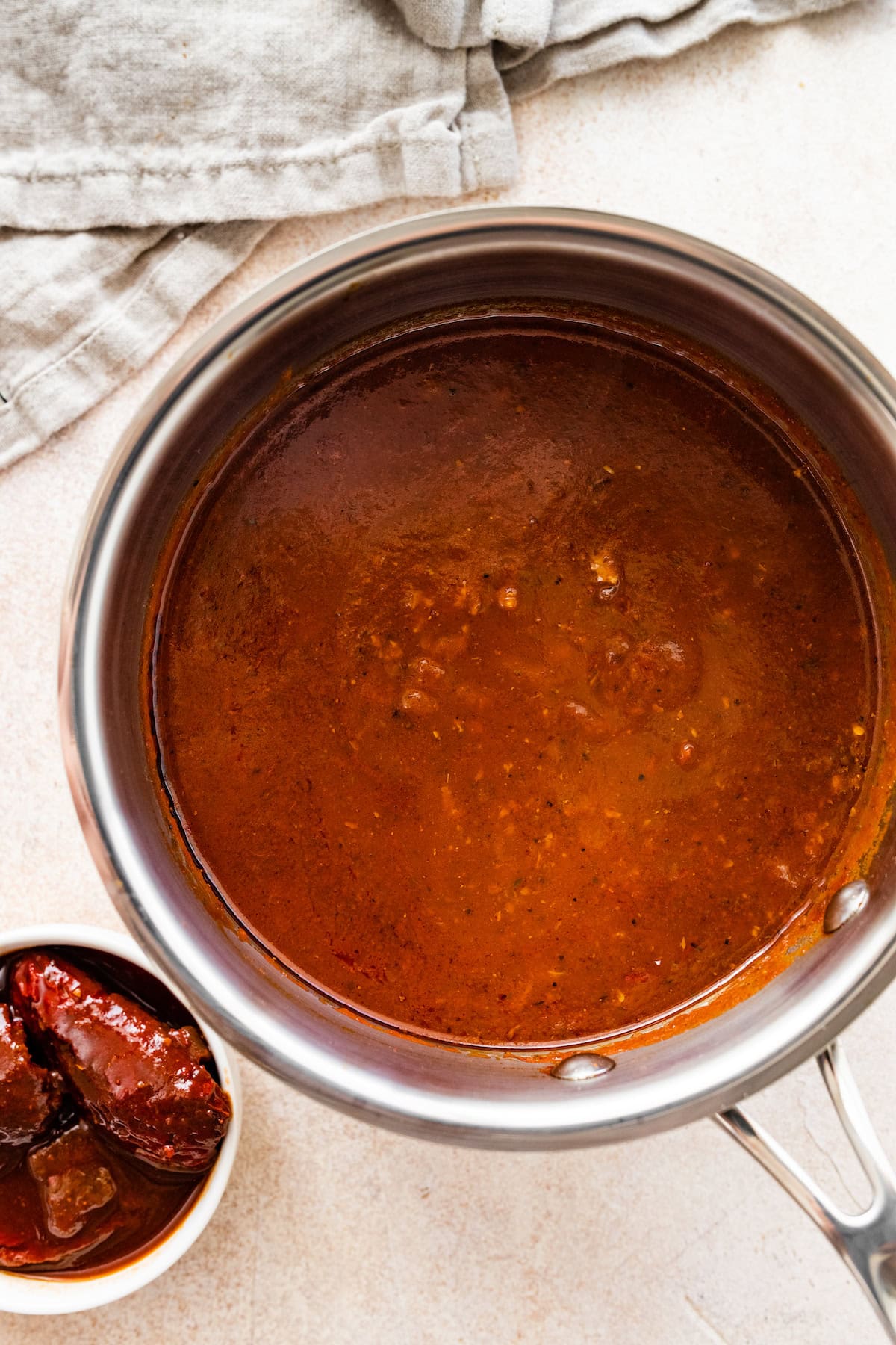 Homemade enchilada sauce simmering in a pot.