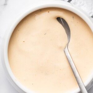 Homemade Big Mac sauce in a white bowl with a silver spoon.