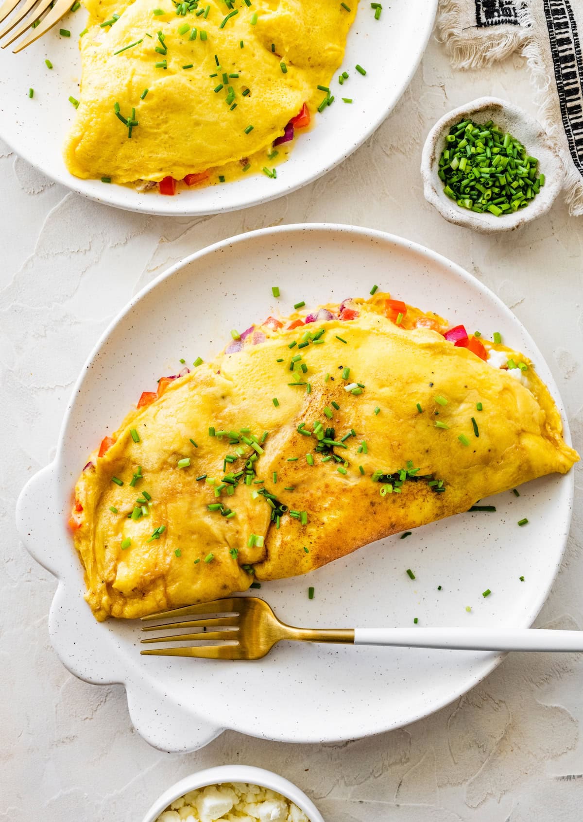 Golden cottage cheese omelette Golden cottage cheese omelette on a plate with chives, ready to slice and serve.