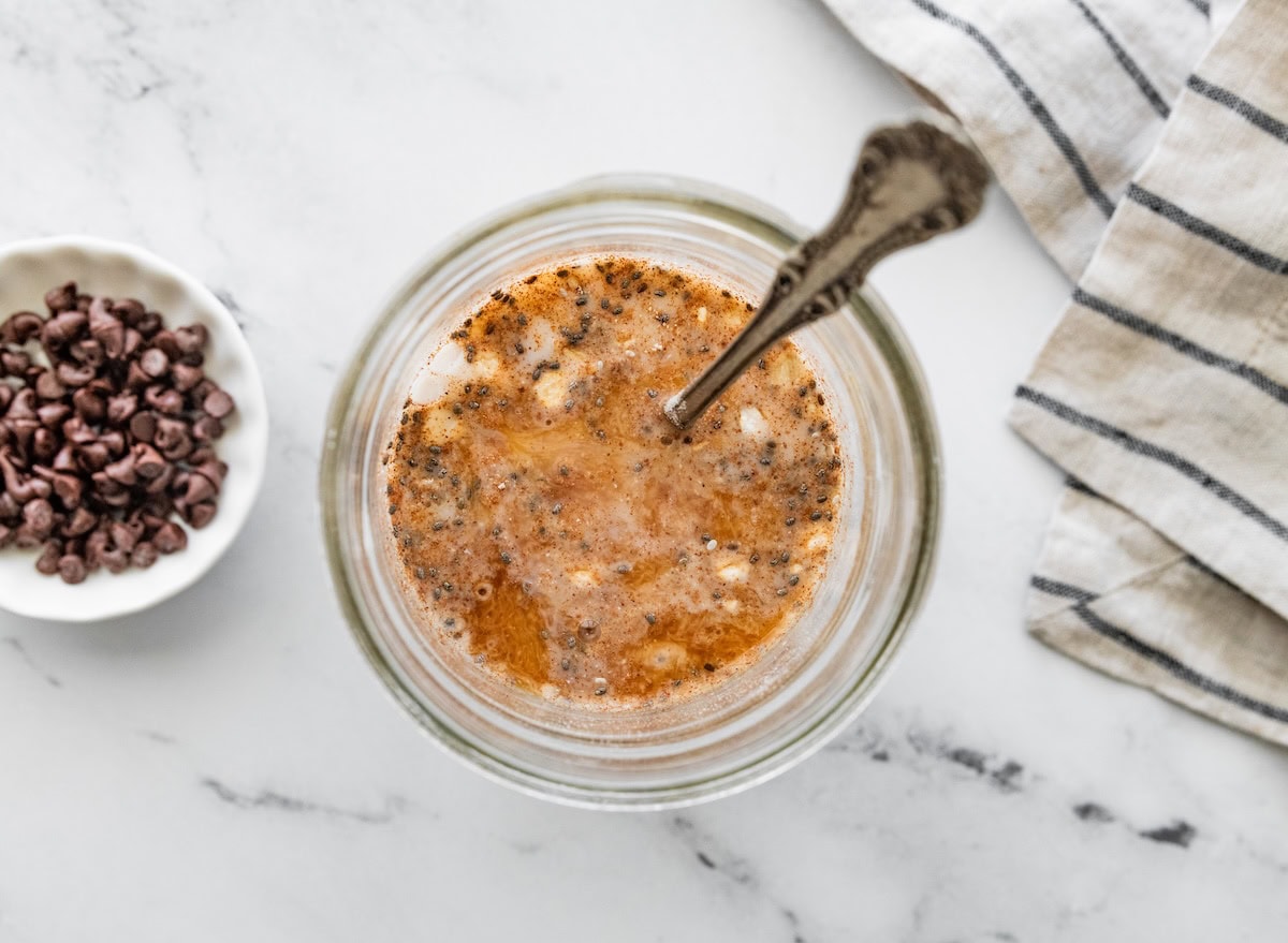 cinnamon and mini chocolate chips Overhead view of cookie dough overnight oats topped with cinnamon and mini chocolate chips.