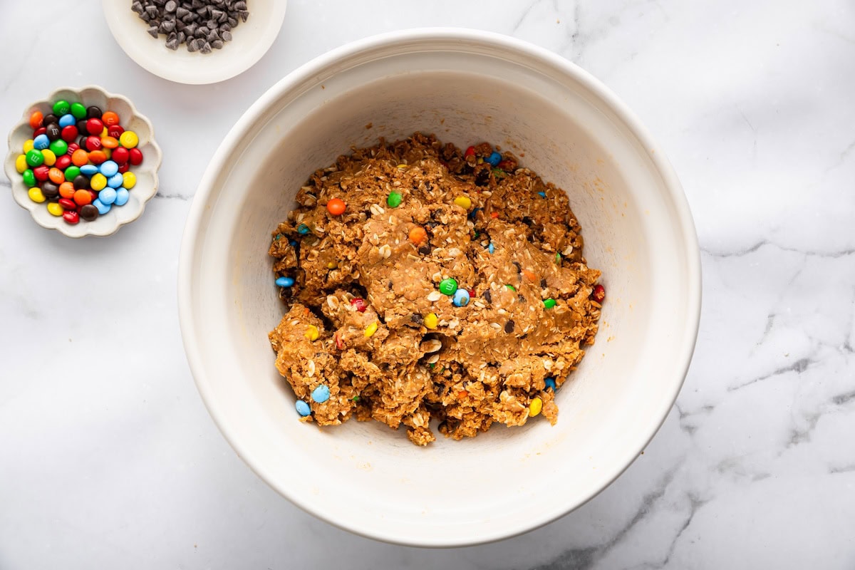Monster cookie protein ball dough Monster cookie protein ball dough mixed in a bowl with oats, chocolate chips, and M&M’s.