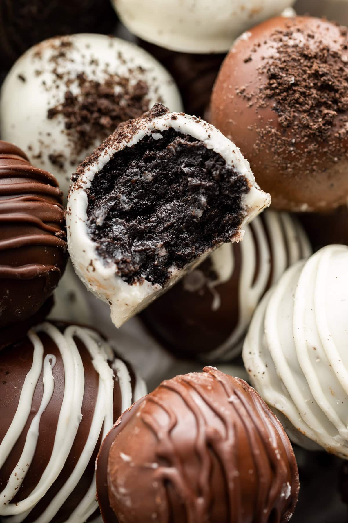 Close up of a bitten Oreo truffle showing the soft chocolatey Oreo center.