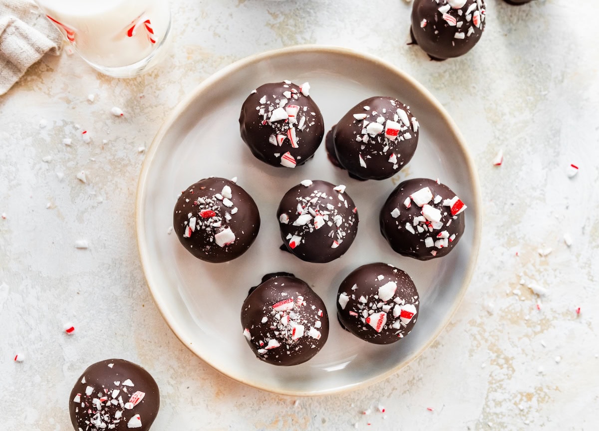 Chocolate peppermint protein balls arranged on a plate.