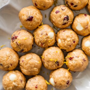A white dish of cranberry orange protein balls.