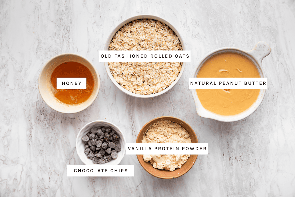 Ingredients for peanut butter protein balls: rolled oats, peanut butter, honey, vanilla protein powder and chocolate chips.