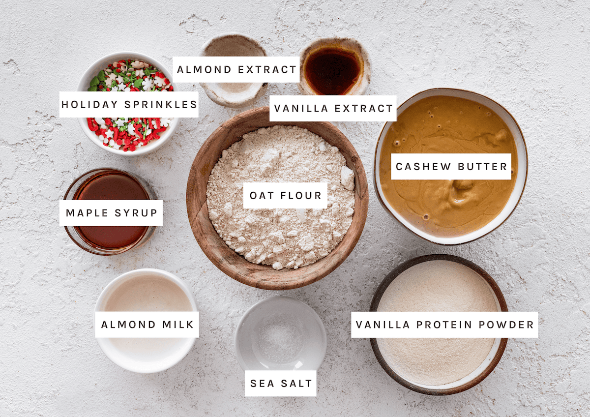Sugar Cookie Protein Balls ingredients Oat flour, cashew butter, vanilla protein powder, maple syrup, almond milk, vanilla extract, almond extract, sea salt, holiday sprinkles
