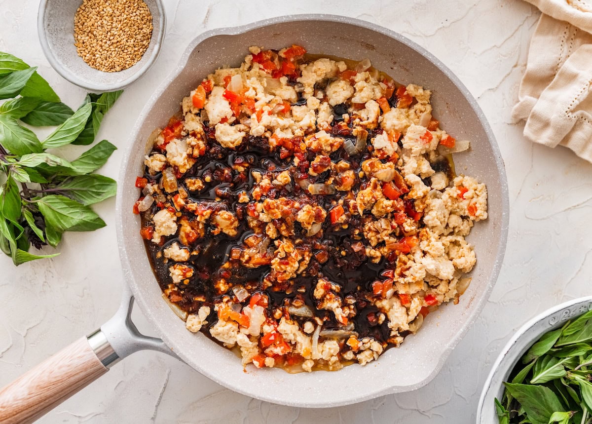 Ground chicken stir fry Ground chicken stir fry in a skillet with dark savory sauce poured over the mixture.