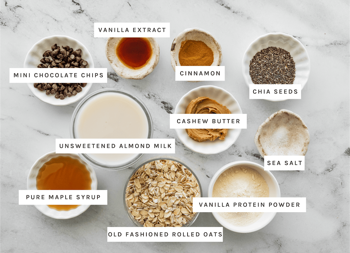 cookie dough overnight oats ingredients Vanilla extract, mini chocolate chips, cinnamon, chia seeds, unsweetened almond milk, cashew butter, sea salt, pure maple syrup, old fashioned rolled oats, vanilla protein powder