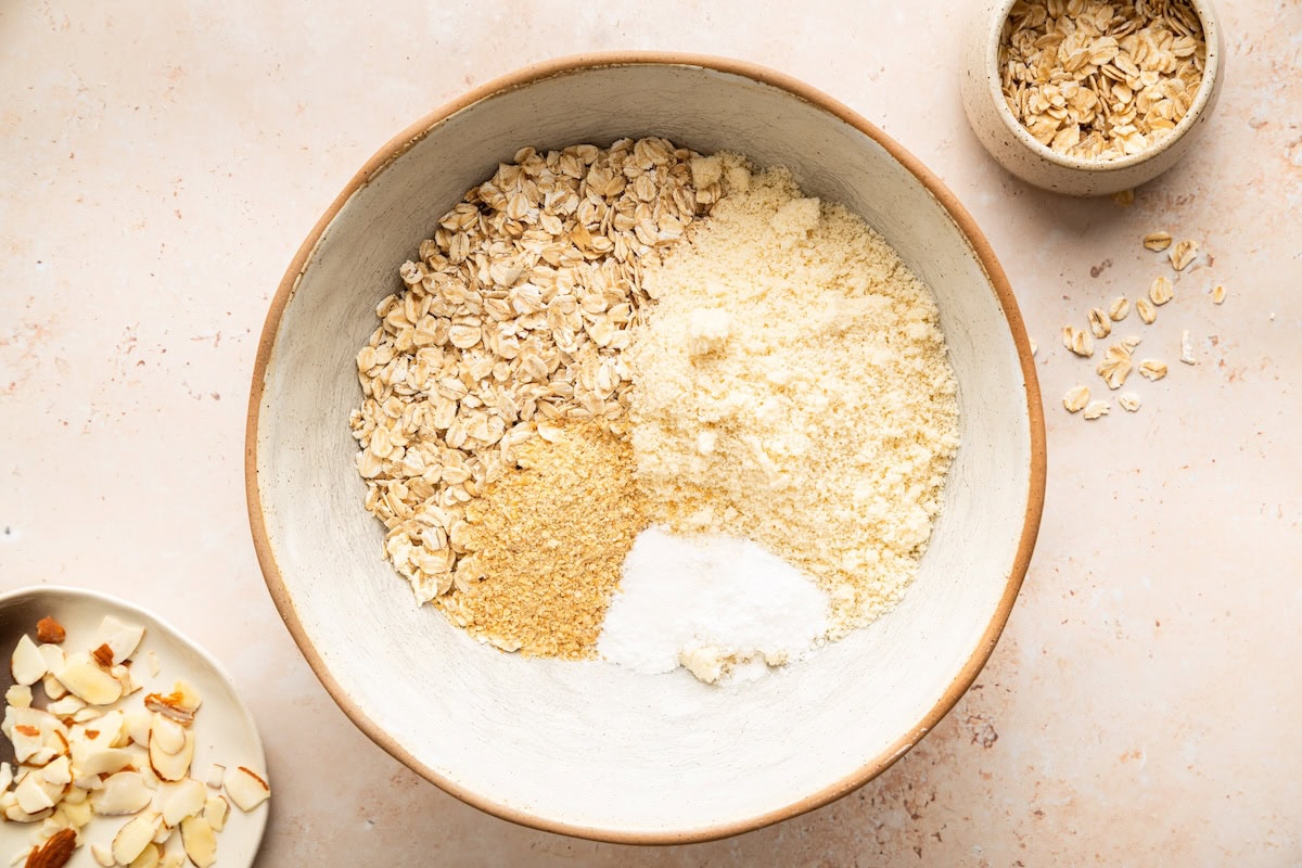 Dry ingredients for almond croissant baked oatmeal in large bowl.