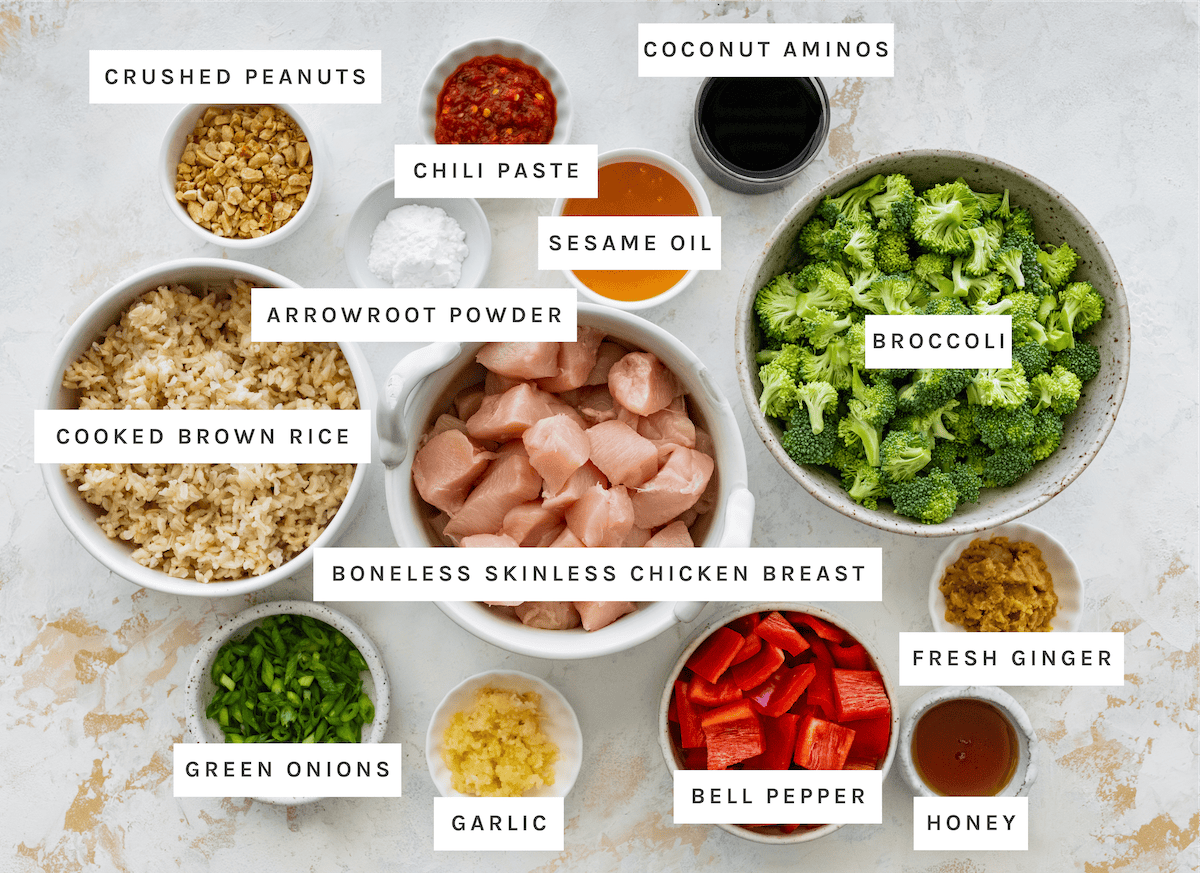 Healthy Kung Pao Chicken ingredients Crushed peanuts, chili paste, coconut aminos, sesame oil, arrowroot powder, cooked brown rice, boneless skinless chicken breast, broccoli, green onions, garlic, bell pepper, fresh ginger, honey