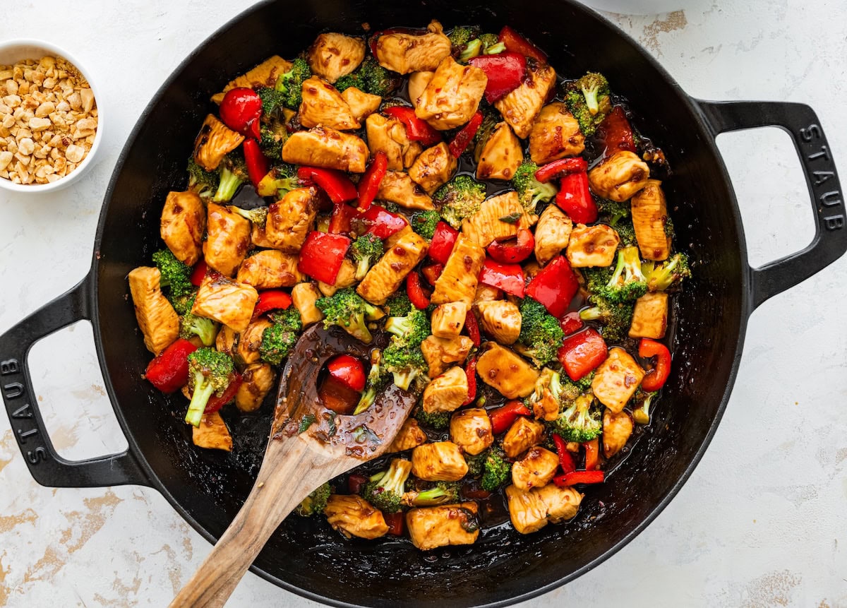 Kung pao chicken recipe Kung pao chicken with bell peppers and broccoli cooking in a skillet