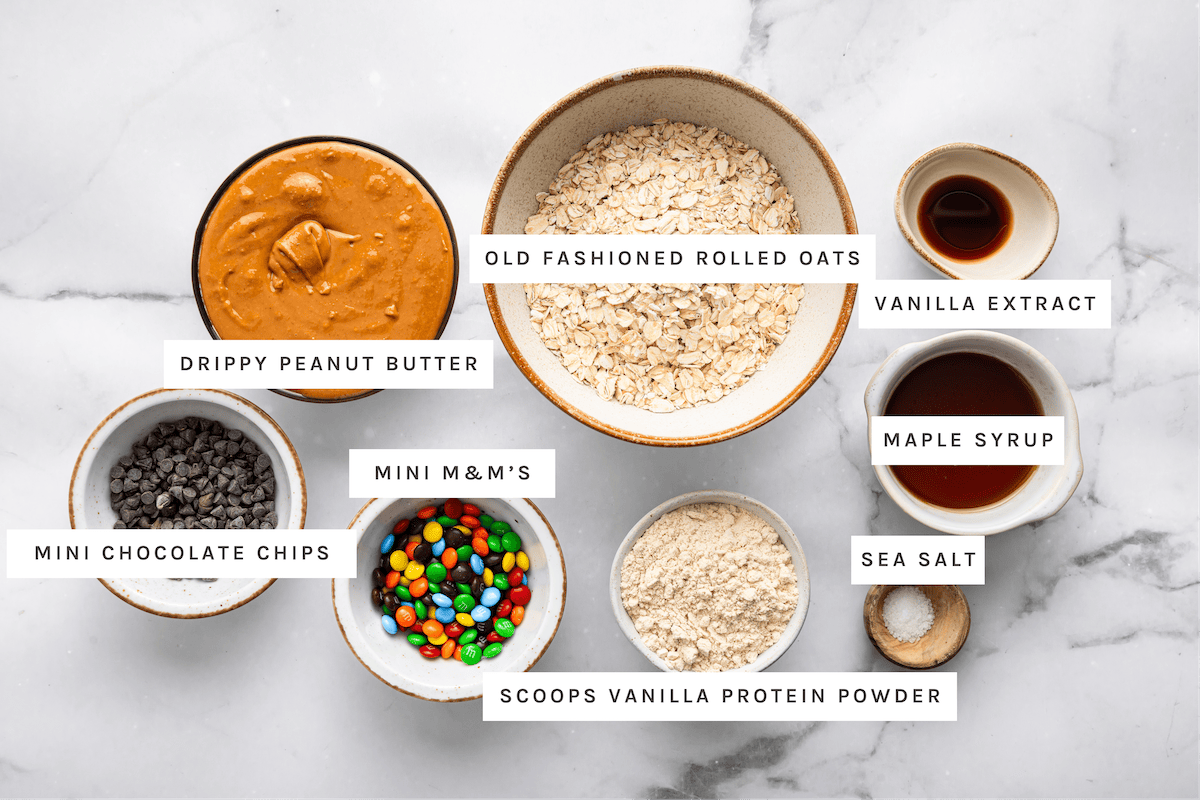 Monster Cookie Protein Balls ingredients Drippy peanut butter, old fashioned rolled oats, vanilla extract, maple syrup, mini chocolate chips, mini M&M’s, vanilla protein powder, sea salt