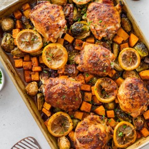 Sheet pan chicken and veggies with roasted Brussels sprouts, butternut squash, and lemon slices.