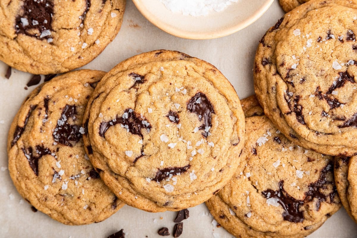 A few brown butter chocolate chip cookies on parchment paper.