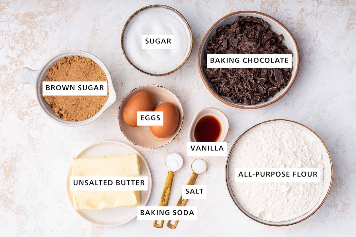 Ingredients measured out to make Brown Butter Chocolate Chip Cookies: unsalted butter, brown sugar, eggs, sugar, baking soda, salt, vanilla, flour and baking chocolate.