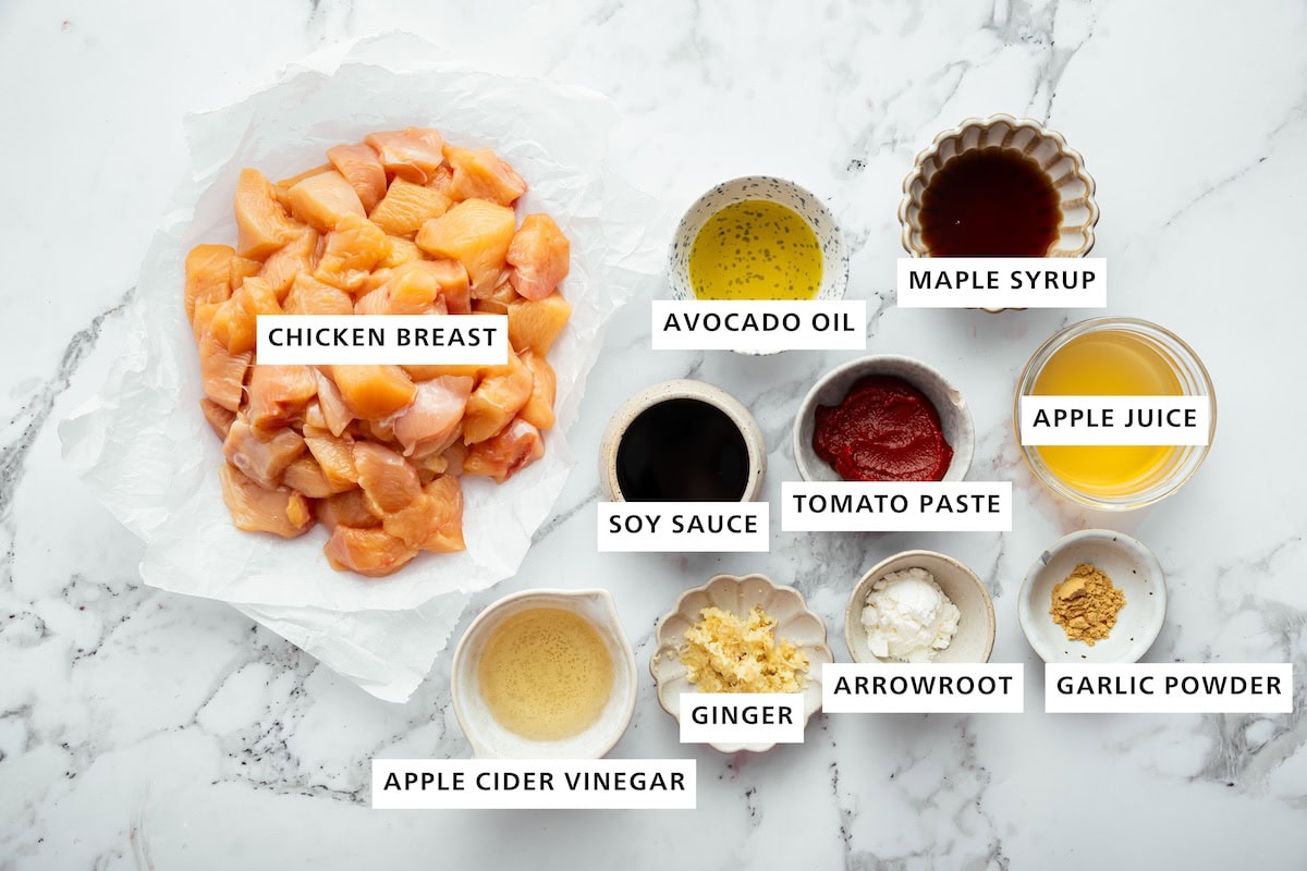 Ingredients for glazed chicken recipe: chicken breast, avocado oil, maple syrup, apple juice, tomato paste, soy sauce, vinegar, ginger, arrowroot and garlic powder.