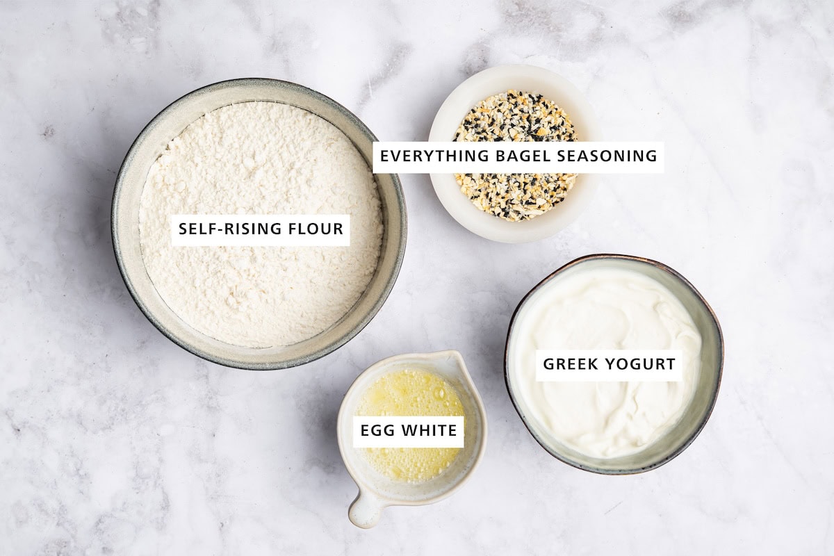Ingredients measured out to make protein bagels: Greek yogurt, everything bagel seasoning, egg white and self-rising flour.
