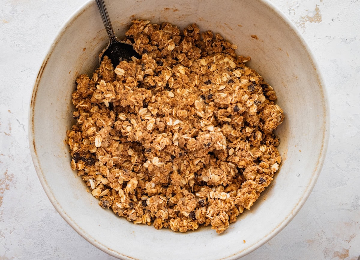 Mixing s’mores protein ball dough in a white mixing bowl.