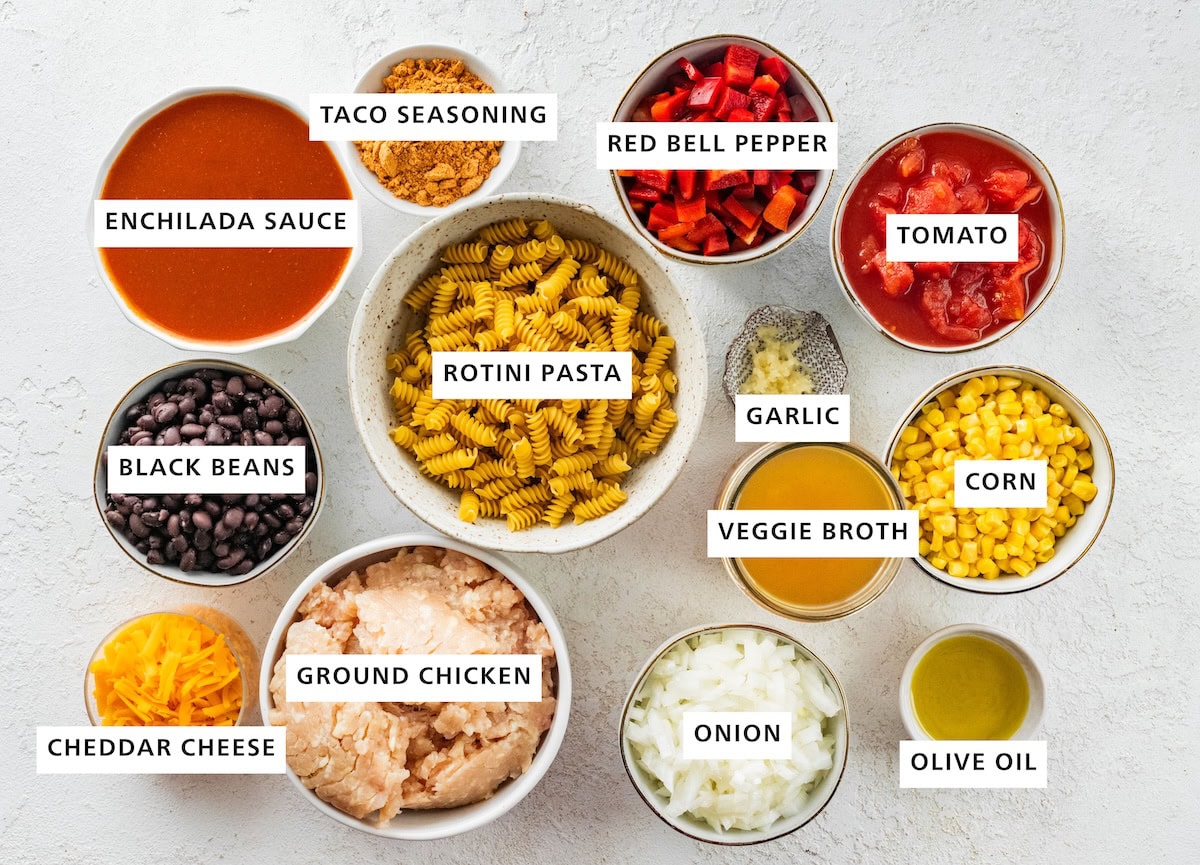 Ingredients for the enchilada pasta: enchilada sauce, black beans, cheese, ground chicken, onion, pasta, veggie broth, olive oil, corn, garlic, tomato and red bell pepper.