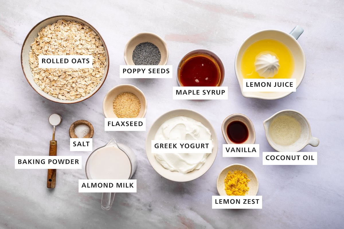 Ingredients for the lemon poppy seed baked oatmeal: rolled oats, poppy seeds, flaxseed, maple syrup, lemon juice, greek yogurt, vanilla, coconut oil, lemon zest, almond milk, salt + baking powder.