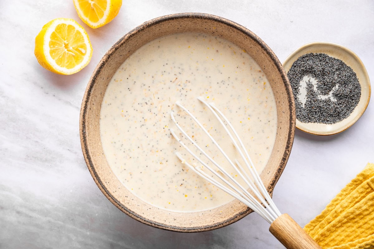 Mixing wet ingredients for lemon poppy seed baked oatmeal in bowl.