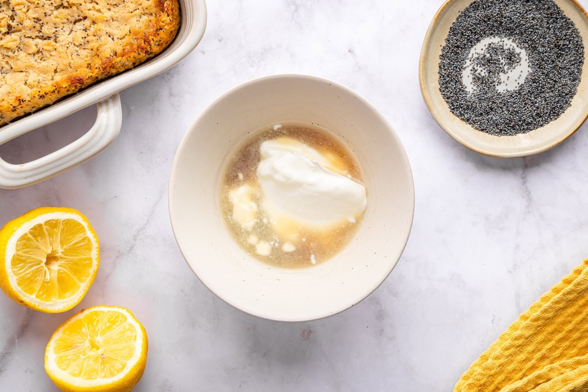 Adding maple syrup and lemon juice to bowl for yogurt glaze.