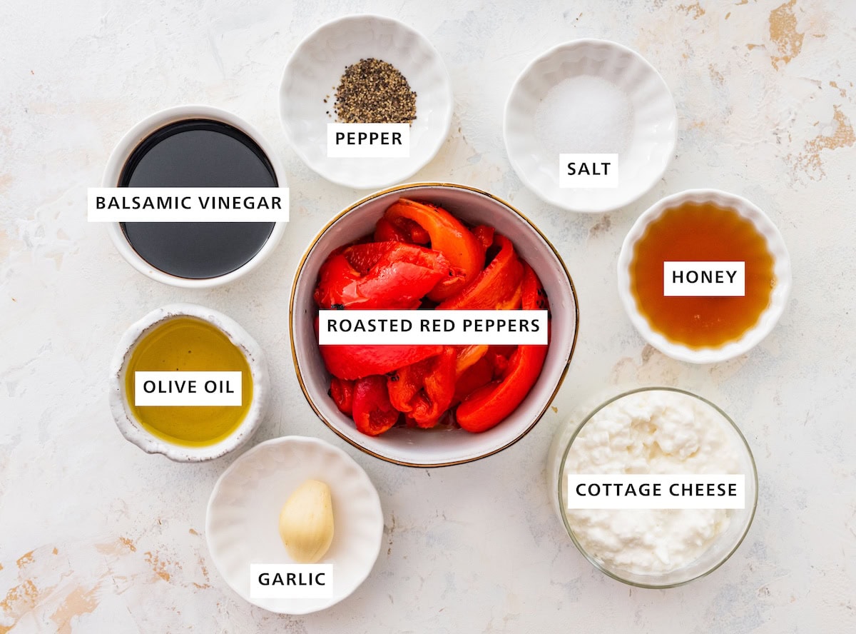 Ingredients for roasted red pepper dressing: roasted red peppers, balsamic vinegar, olive oil, garlic, salt, pepper, honey and cottage cheese.