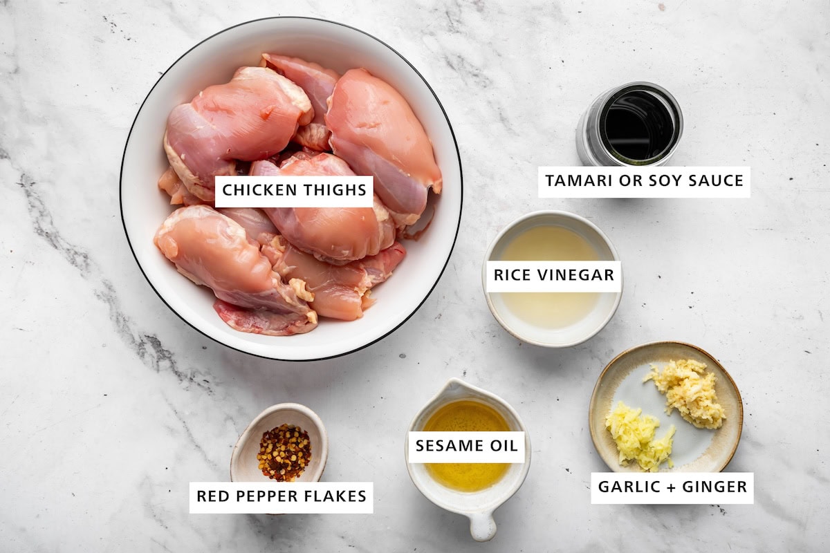 Ingredients measured out for teriyaki chicken: chicken thighs, tamari or soy sauce, rice vinegar, garlic, ginger, sesame oil, and red pepper flakes.