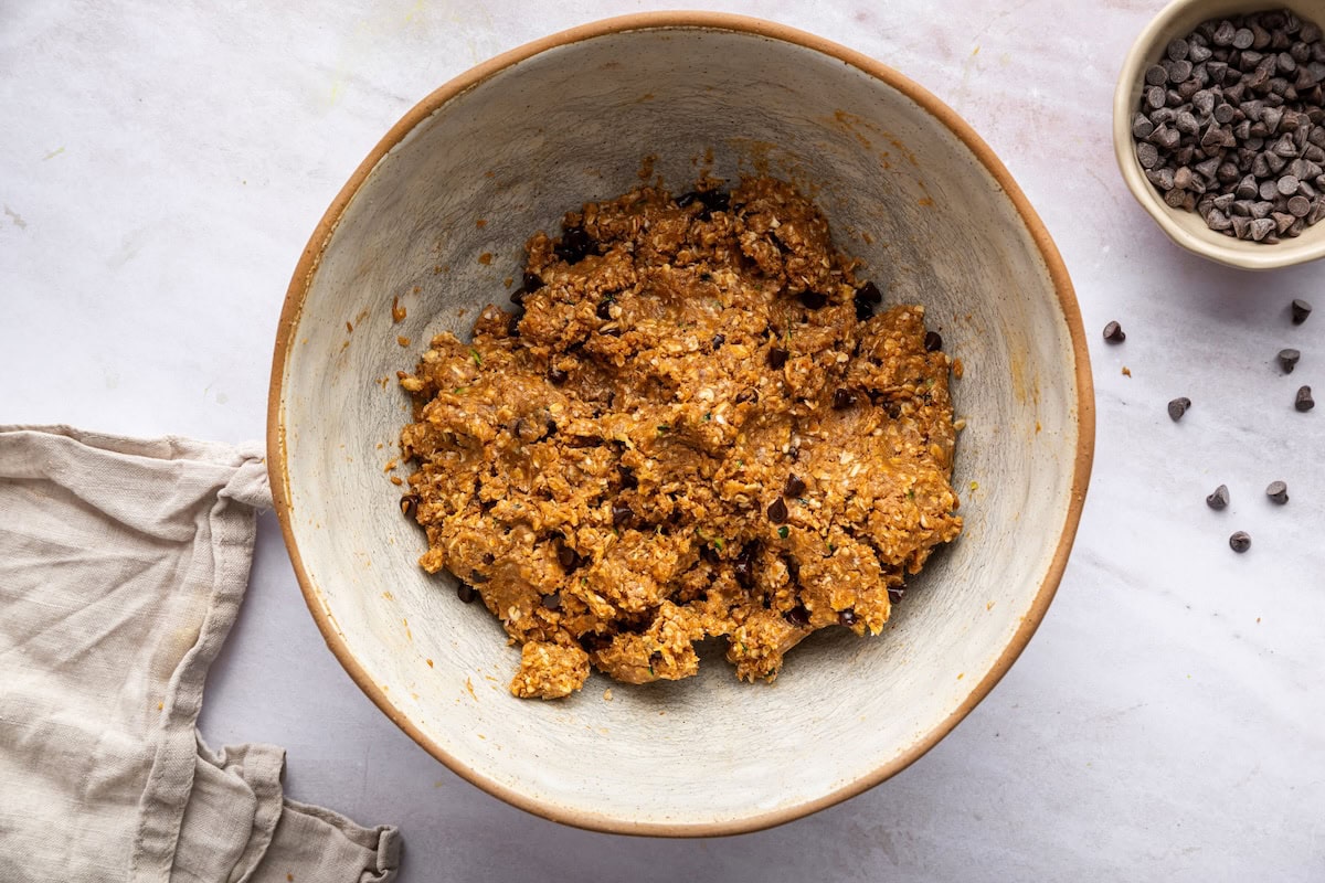 Zucchini bread protein ball dough mixed together in a ceramic bowl.