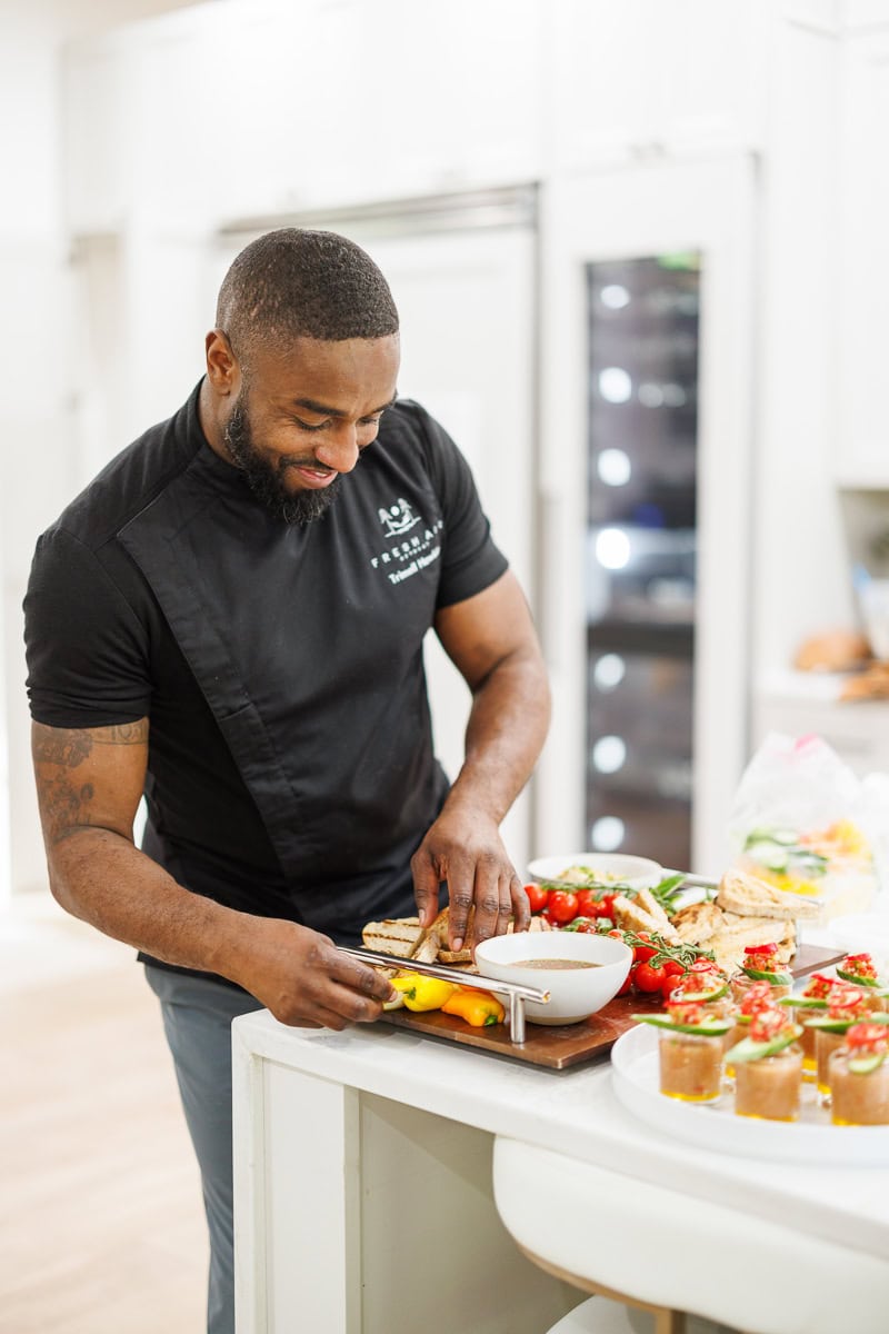 Chef preparing a Mediterranean appetizer board at a Fresh Air Retreat event in Atlanta.