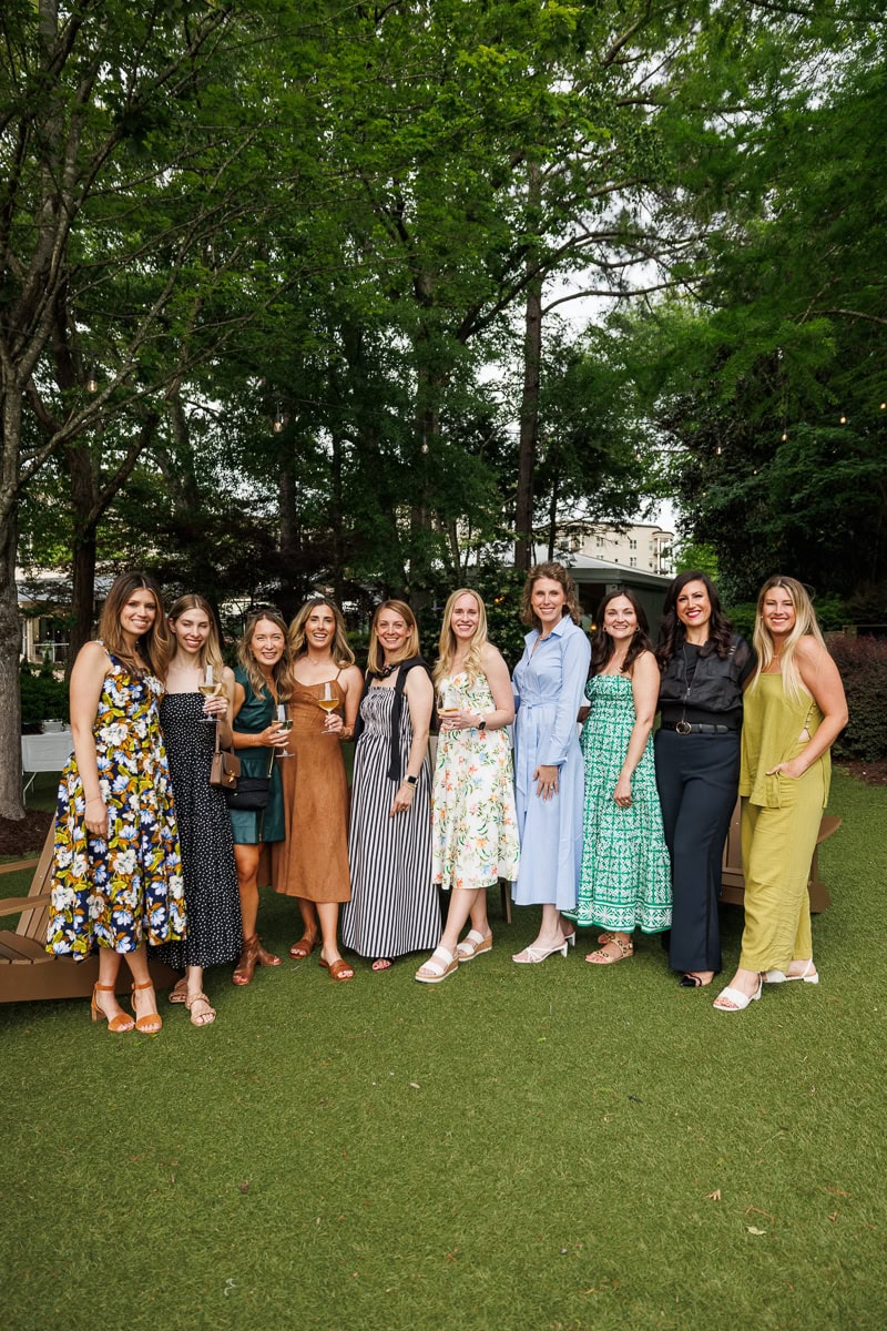 A group of food bloggers posing together outside during an Atlanta event.