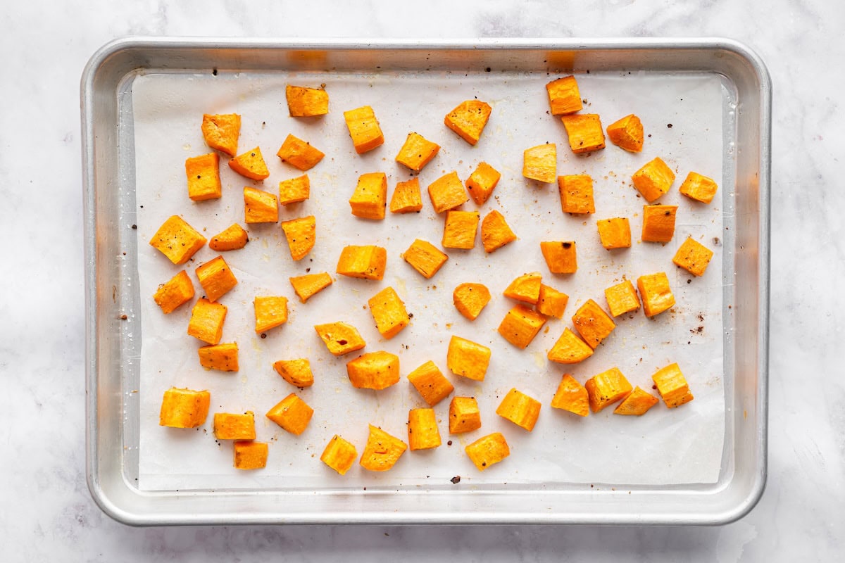 Diced sweet potatoes on a baking tray.