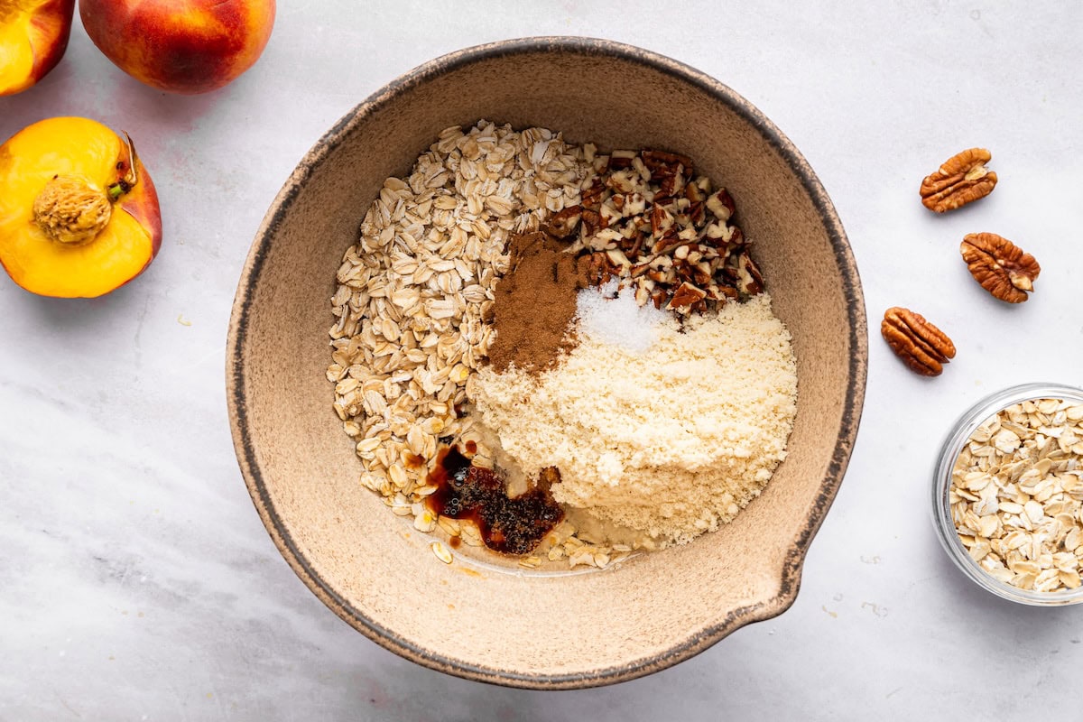 Oats, pecans, almond flour, cinnamon, salt, and maple syrup in a large mixing bowl.