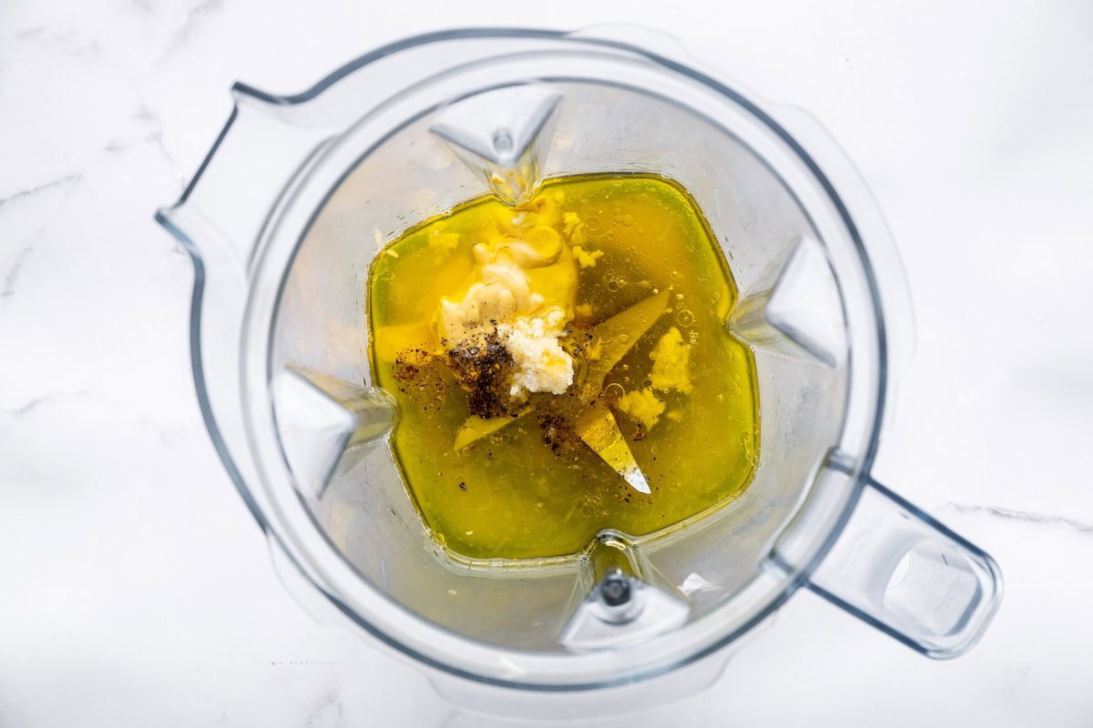Honey mustard dressing ingredients in a blender before being blended.