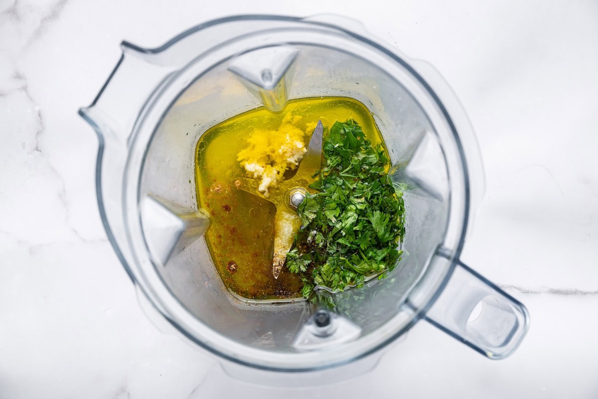Ingredients for a cilantro lime dressing in a blender before being blended.