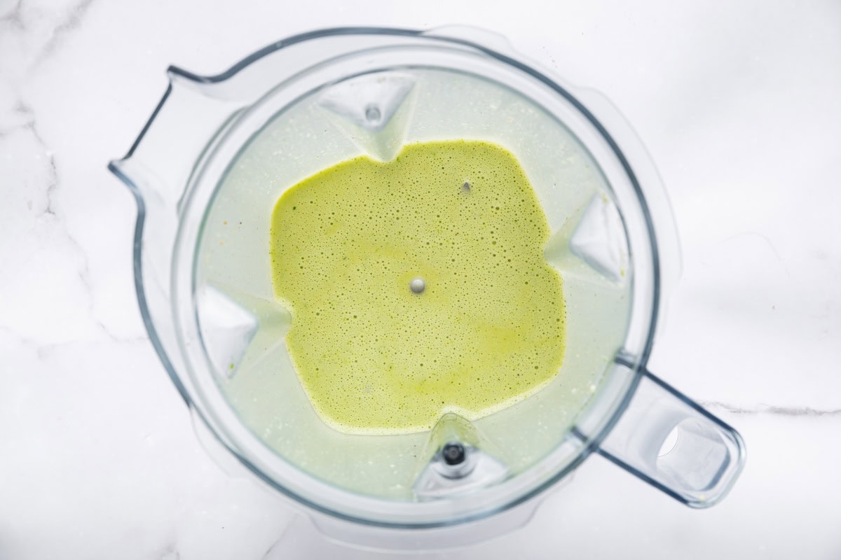 A cilantro lime dressing in a blender.